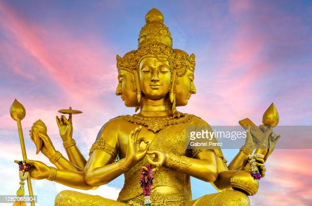 This is a statue of Lord Brahma atop a hill at a Buddhist temple in Chiang Mai, Thailand.